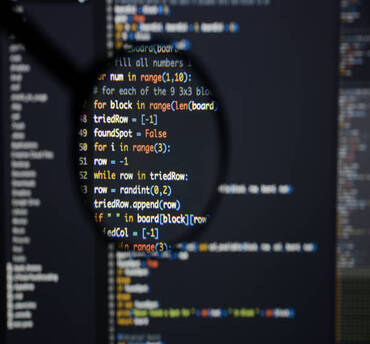 Real Python code developing screen. Programing workflow abstract algorithm concept. Lines of Python code visible under magnifying lens.